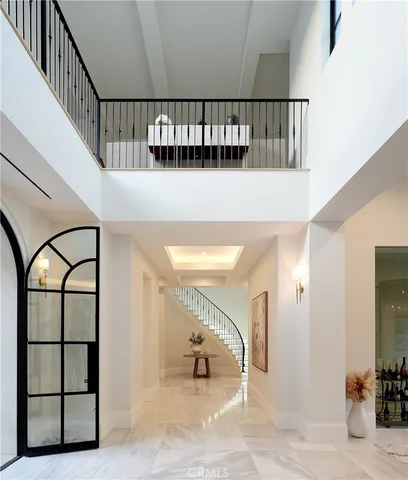 a view of staircase with furniture and a window