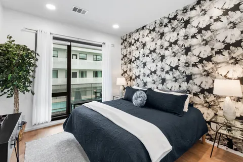 a bedroom with a bed and a potted plant