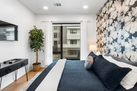 a living room with furniture and a potted plant