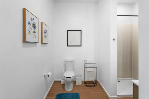 a white toilet sitting next to a bathroom sink