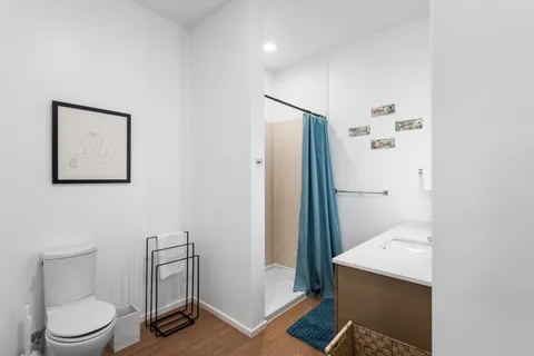 a bathroom with a toilet and a shower