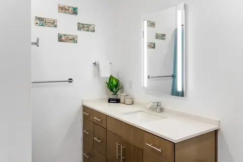 a bathroom with a sink a vanity and a mirror