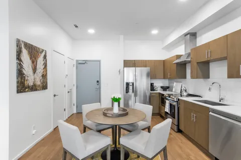a view of a kitchen with a dining table and chairs