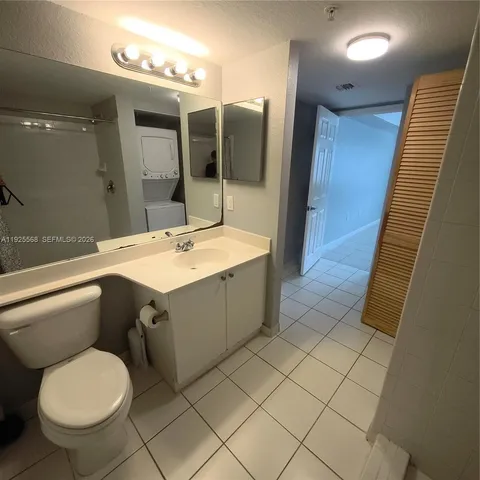 a bathroom with a sink mirror vanity and toilet