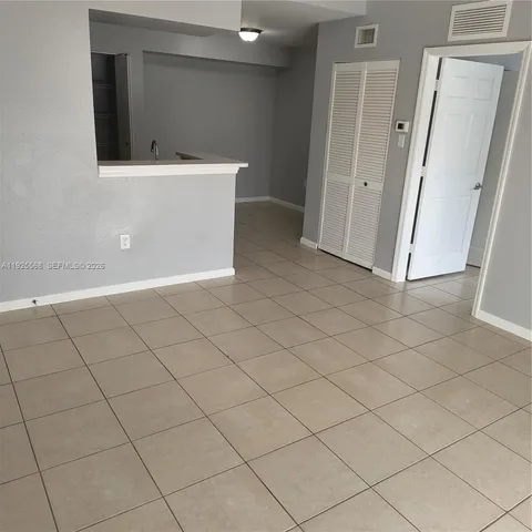 a view of an empty room and wooden floor
