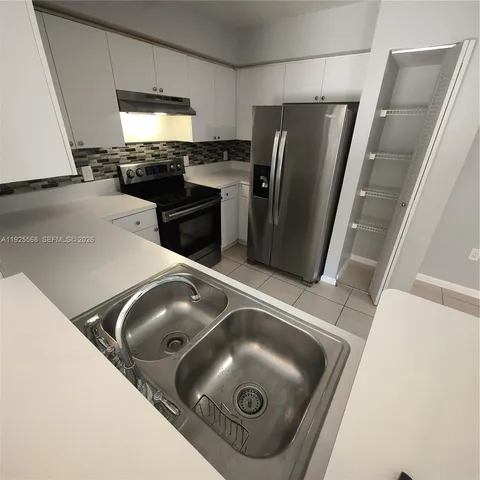 a close view of stove and refrigerator