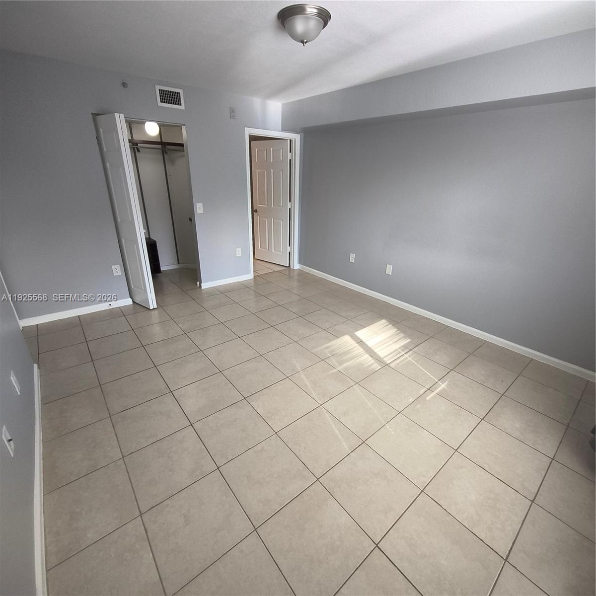 15440 Southwest 284th Street, Unit 5303 Homestead, FL 33033 - Photo 6 of 18 a view of an empty room and a window