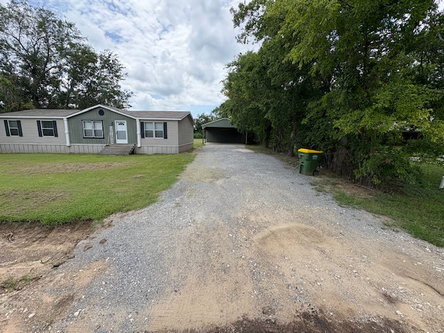 116 Taft Street Normangee, TX 77871 - Photo 2 of 33 a view of a yard in front of a house with a large tree