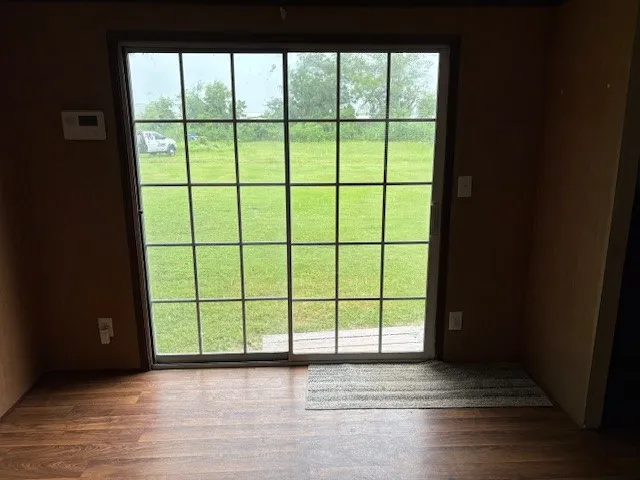 a view of a hallway with a wooden door