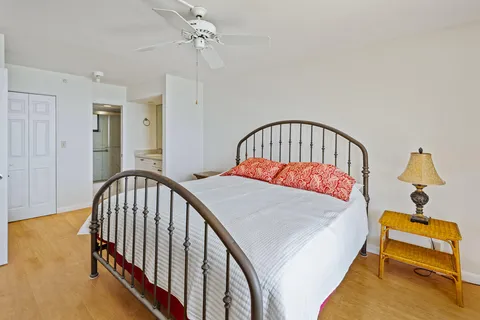 a bedroom with a bed and wooden floor