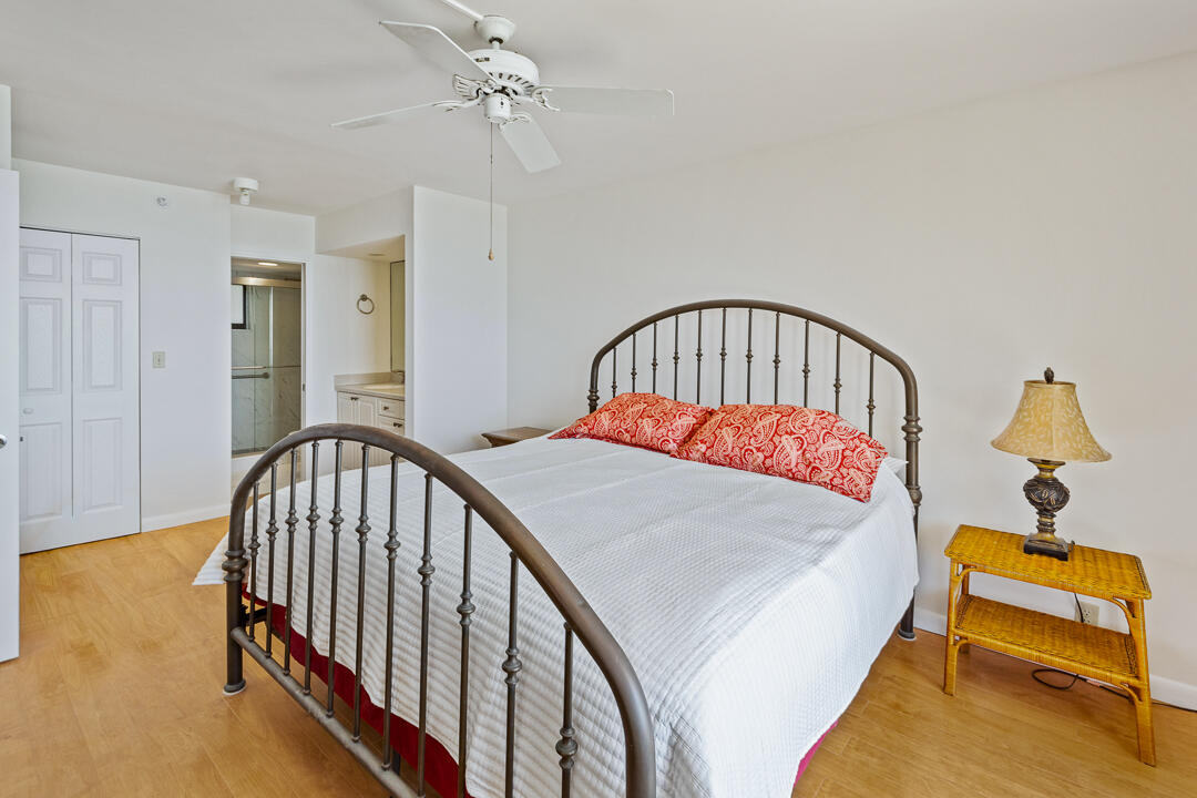 400 Ocean Trail Way, Unit 1108 Jupiter, FL 33477 - Photo 20 of 41 a bedroom with a bed and wooden floor
