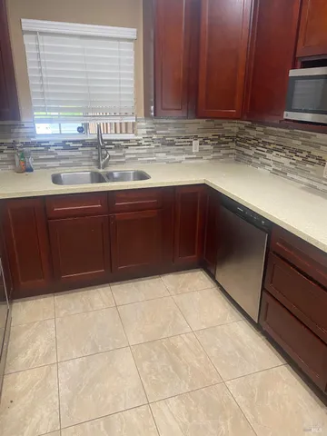 a view of kitchen with granite countertop cabinets
