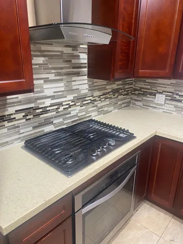 a stove top oven sitting inside of a kitchen