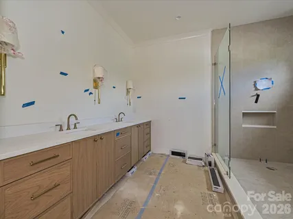 a spacious bathroom with a tub sink and mirror