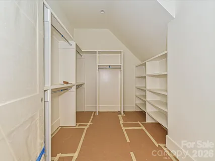 a room with walk in closet and a window