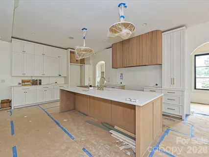 a kitchen with a sink window and cabinets