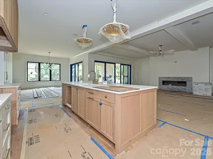 a large white kitchen with a large window