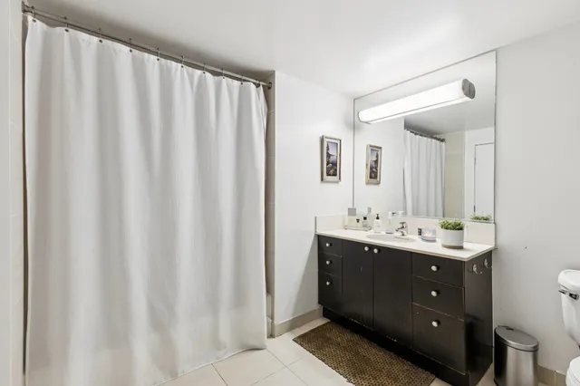 a bathroom with a double vanity sink and mirror
