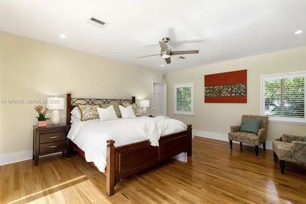 a spacious bedroom with a bed and a couch