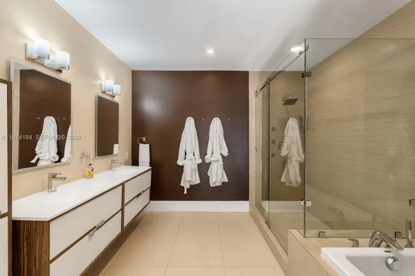 a bathroom with a double vanity sink and mirror