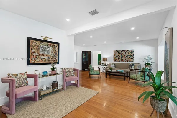 a living room with furniture and wooden floor