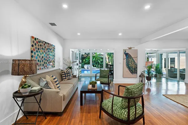 a living room with furniture and a wooden floor