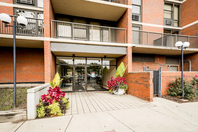 a front view of a building with sitting area