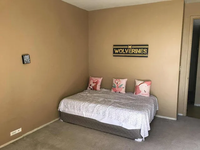 a bedroom with a bed and a table