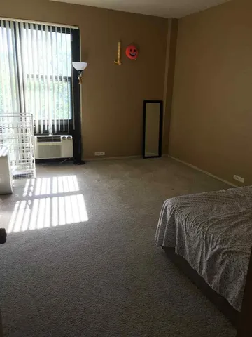 a bed sitting in a room next to a window