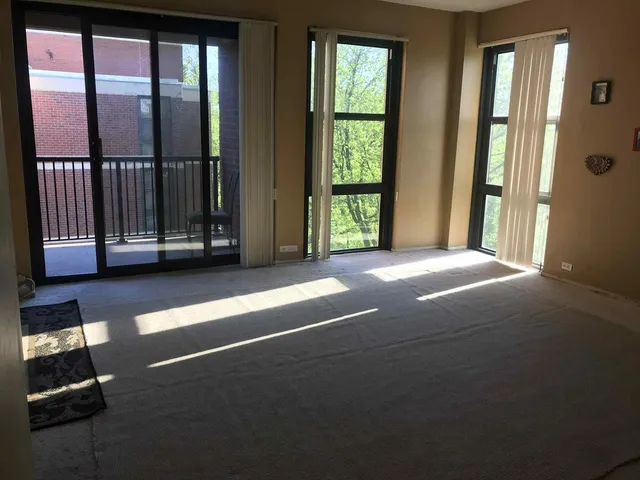 a view of a livingroom with a furniture and floor to ceiling window