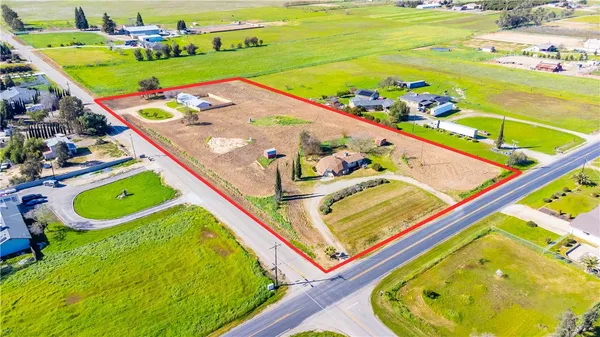 a kitchen with stainless steel appliances granite countertop a refrigerator a sink a stove top oven and cabinets