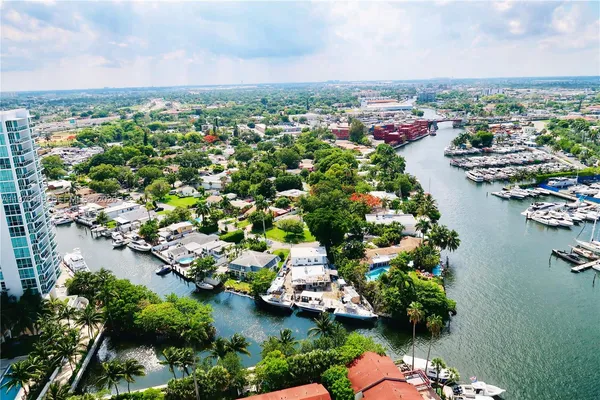 an aerial view of a houses with a lake view