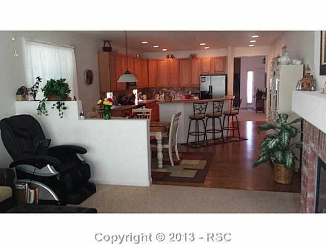 9373 St.George Road Peyton, CO 80831 - Photo 15 of 22 Family room looking back into eat-in area and kitchen.