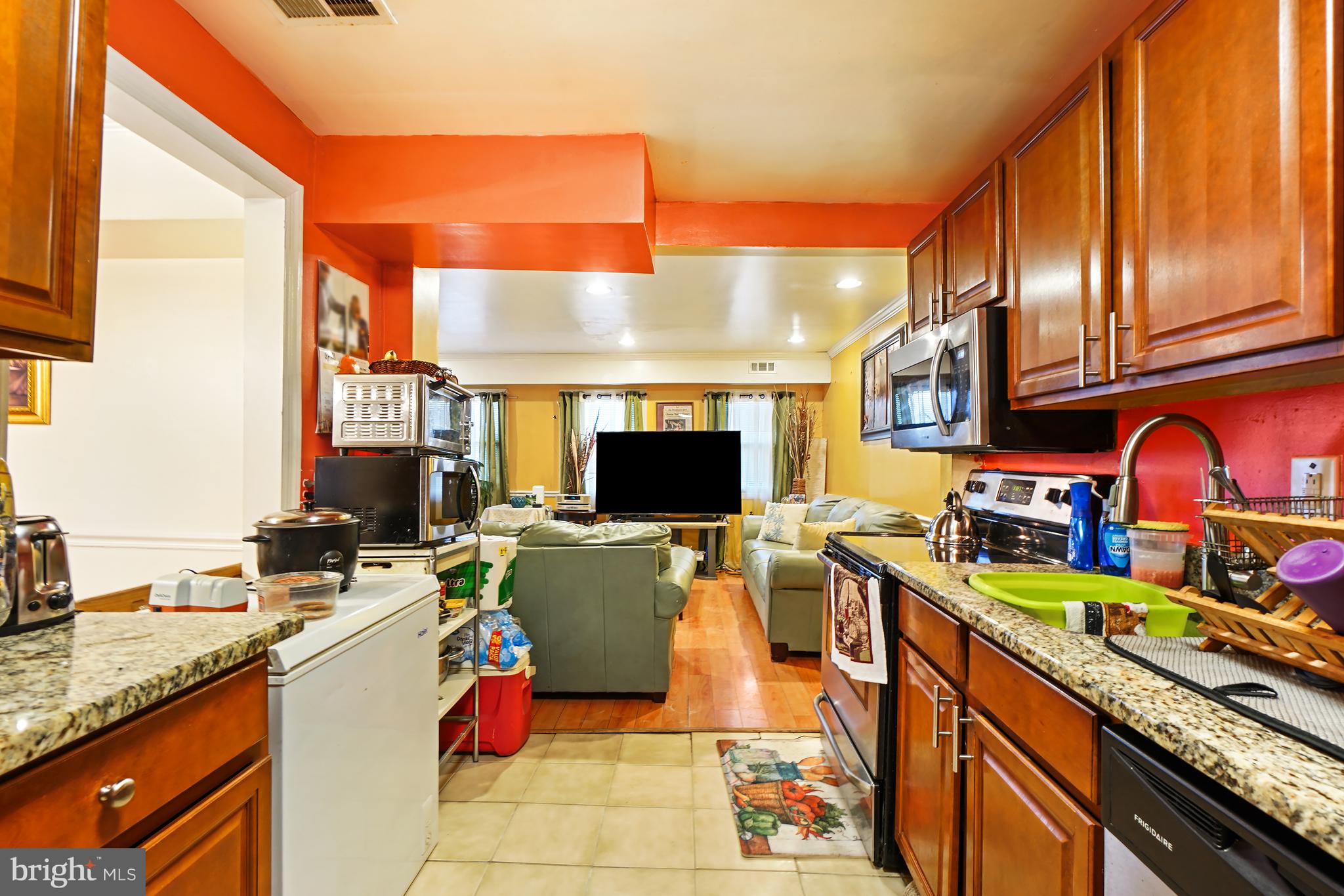 1018 45th Street Northeast Washington, DC 20019 - Photo 12 of 30 a kitchen with stainless steel appliances granite countertop a stove top oven a sink dishwasher and cabinets with wooden floor