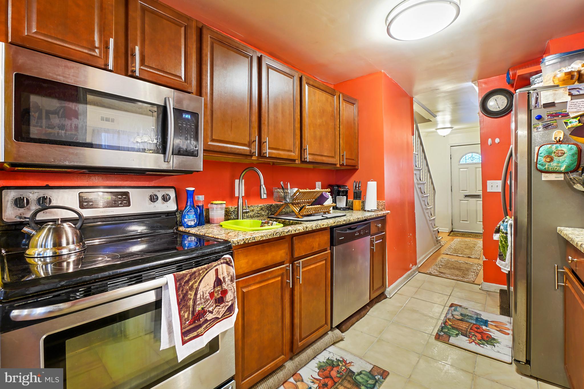 1018 45th Street Northeast Washington, DC 20019 - Photo 13 of 30 a kitchen with stainless steel appliances granite countertop a stove a sink and a microwave