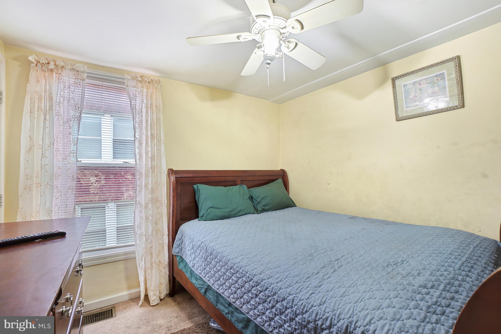 1018 45th Street Northeast Washington, DC 20019 - Photo 17 of 30 a bedroom with a bed chandelier and a window
