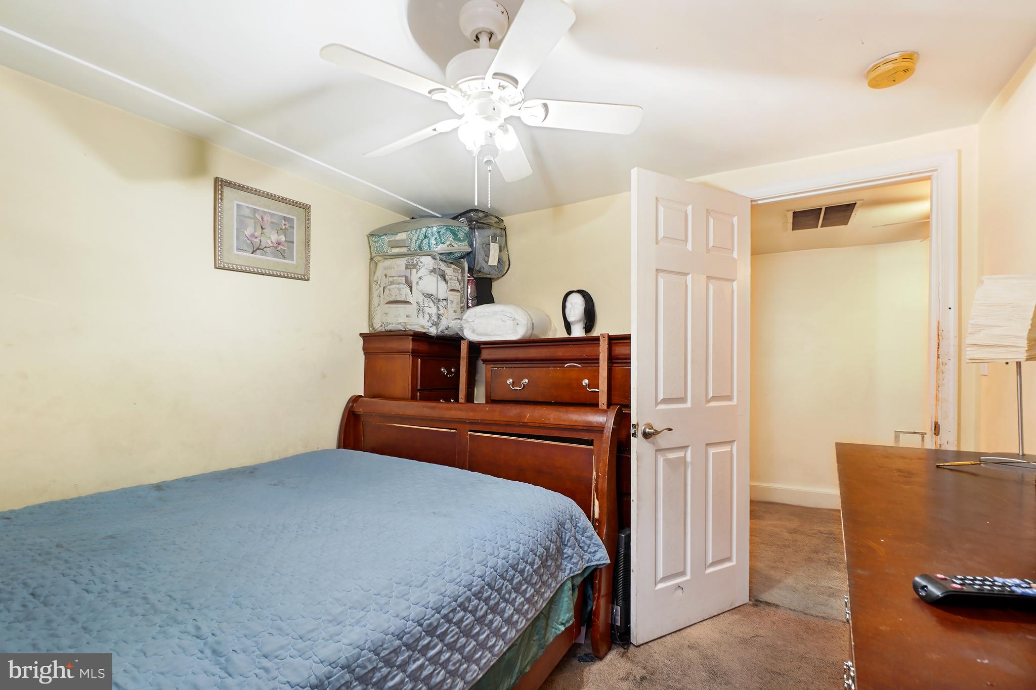 1018 45th Street Northeast Washington, DC 20019 - Photo 18 of 30 a bedroom with a bed and chandelier