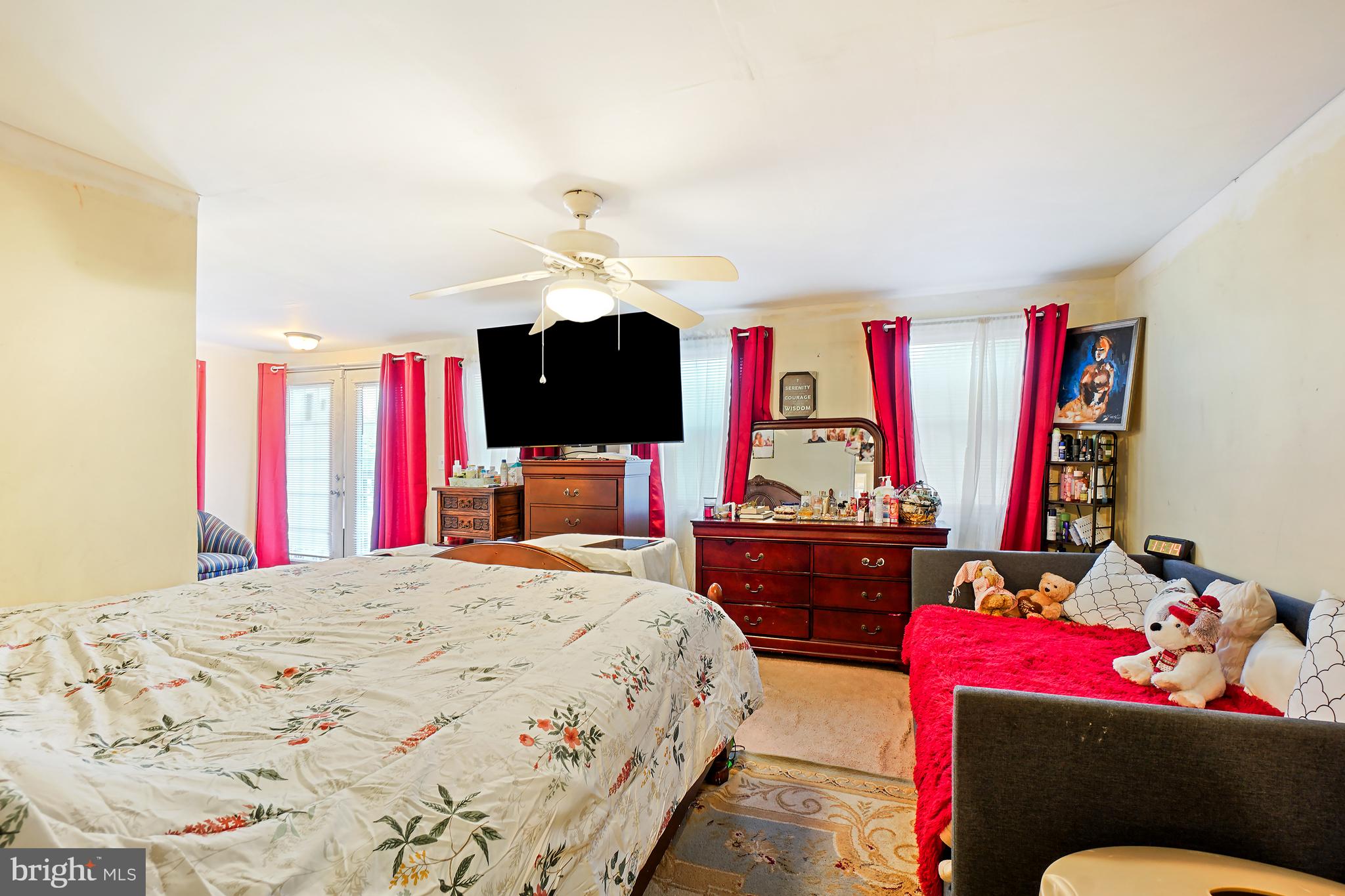 1018 45th Street Northeast Washington, DC 20019 - Photo 19 of 30 a bedroom with a bed dresser and a flat screen tv
