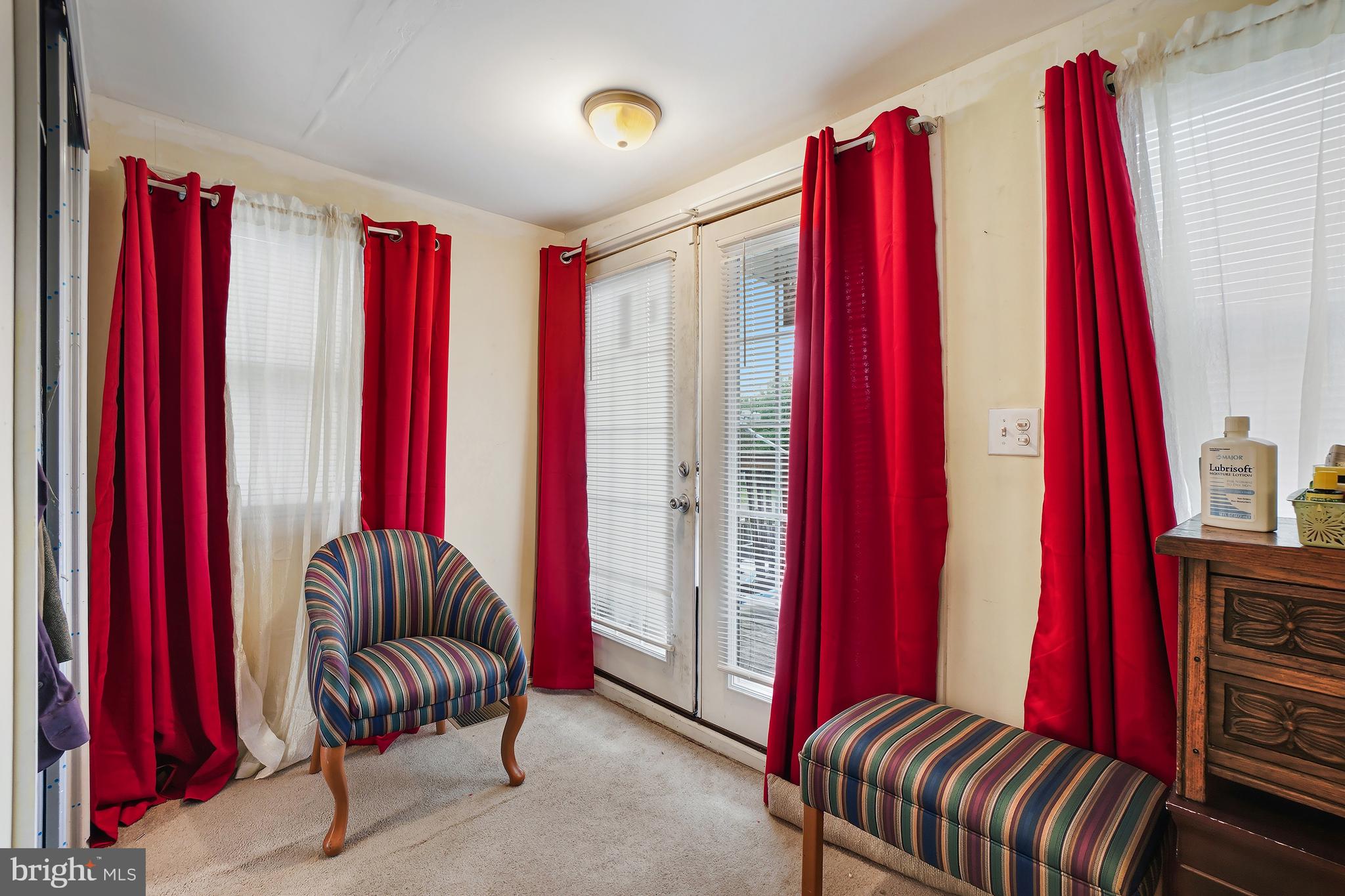 1018 45th Street Northeast Washington, DC 20019 - Photo 21 of 30 a living room with a red couch and a red chair with a large mirror
