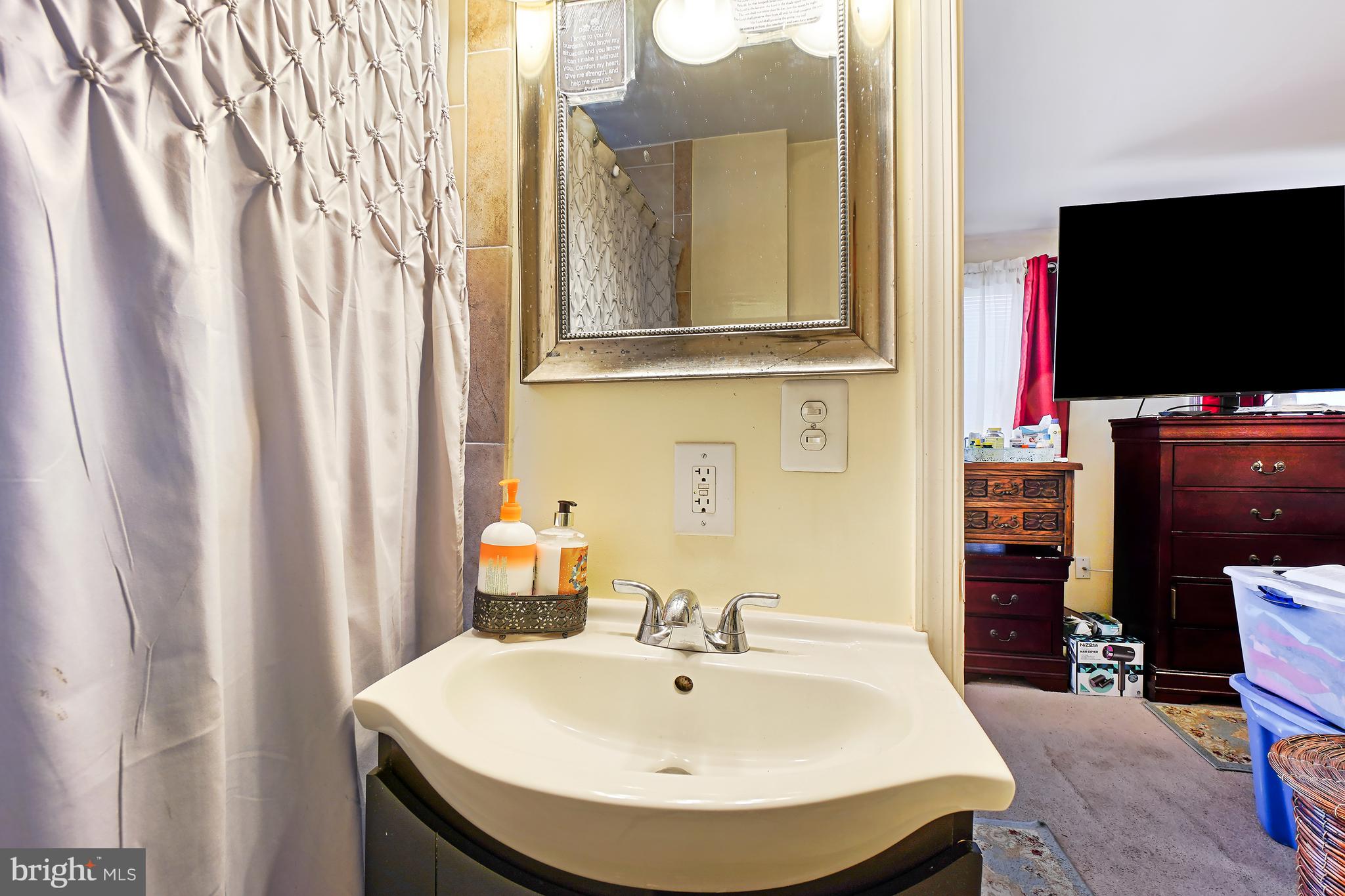 1018 45th Street Northeast Washington, DC 20019 - Photo 23 of 30 a bathroom with a sink and a mirror