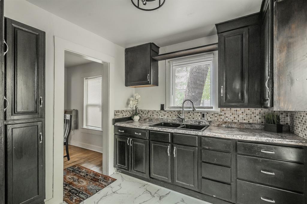 5643 Cary Street Dallas, TX 75227 - Photo 11 of 23 a bathroom with a granite countertop sink and a mirror