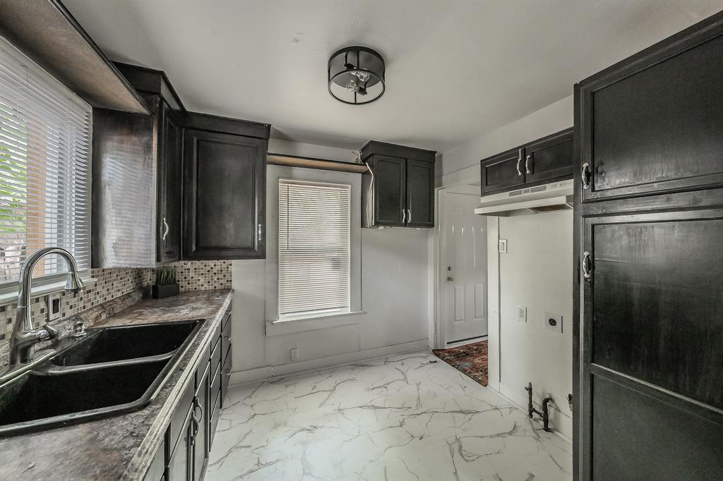 5643 Cary Street Dallas, TX 75227 - Photo 12 of 23 a bathroom with a sink and a mirror