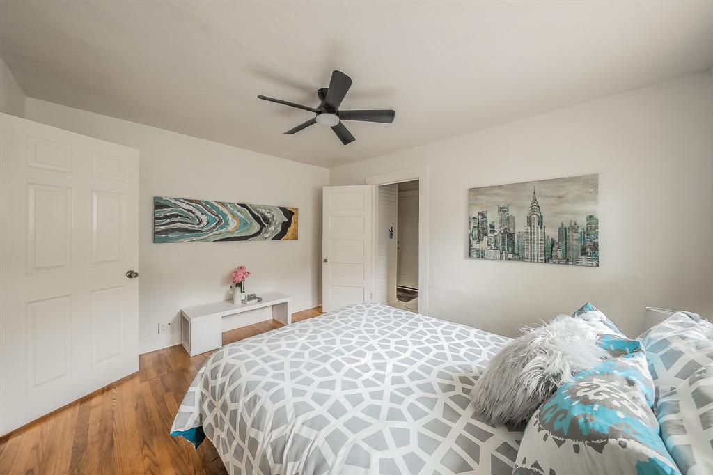 5643 Cary Street Dallas, TX 75227 - Photo 15 of 23 a bedroom with a bed and a chandelier