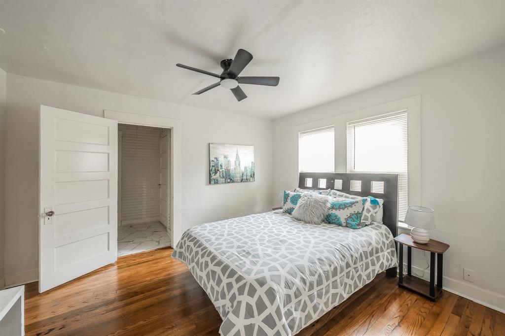 5643 Cary Street Dallas, TX 75227 - Photo 17 of 23 a bedroom with a large bed and a window