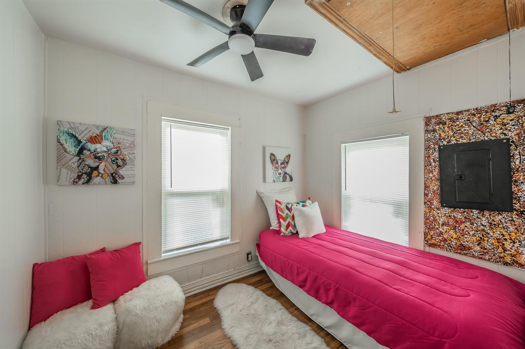 5643 Cary Street Dallas, TX 75227 - Photo 18 of 23 a bedroom with a bed and a couch
