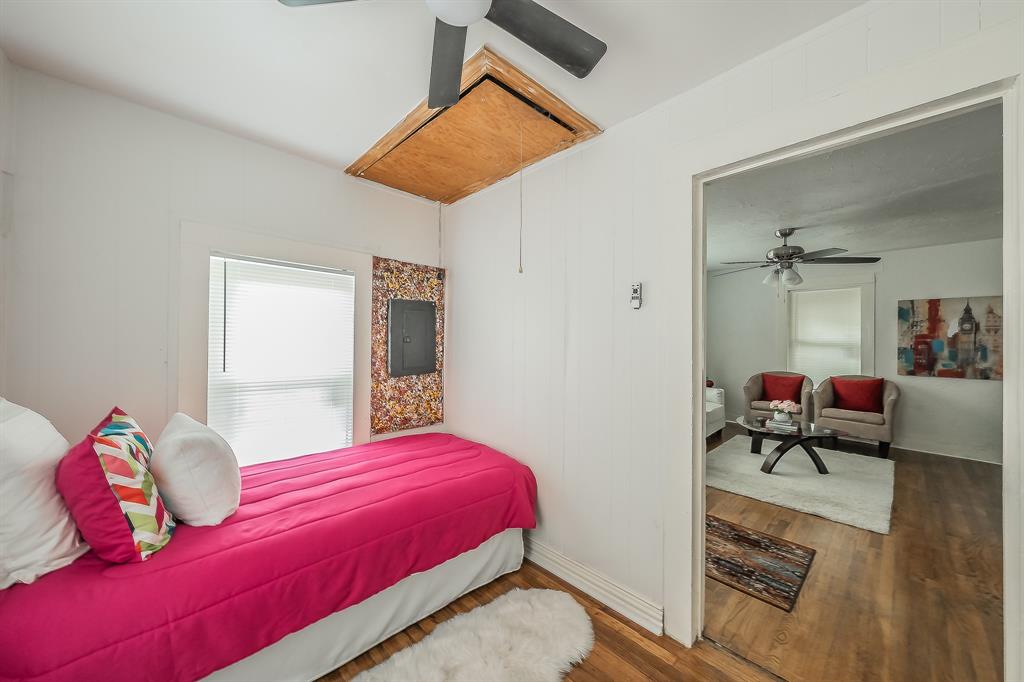 5643 Cary Street Dallas, TX 75227 - Photo 19 of 23 a bedroom with a bed and a dresser