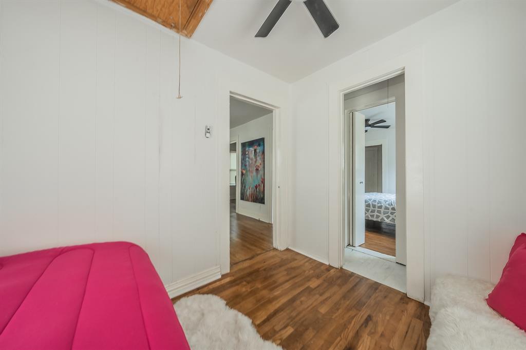 5643 Cary Street Dallas, TX 75227 - Photo 20 of 23 a bedroom with a bed and a window