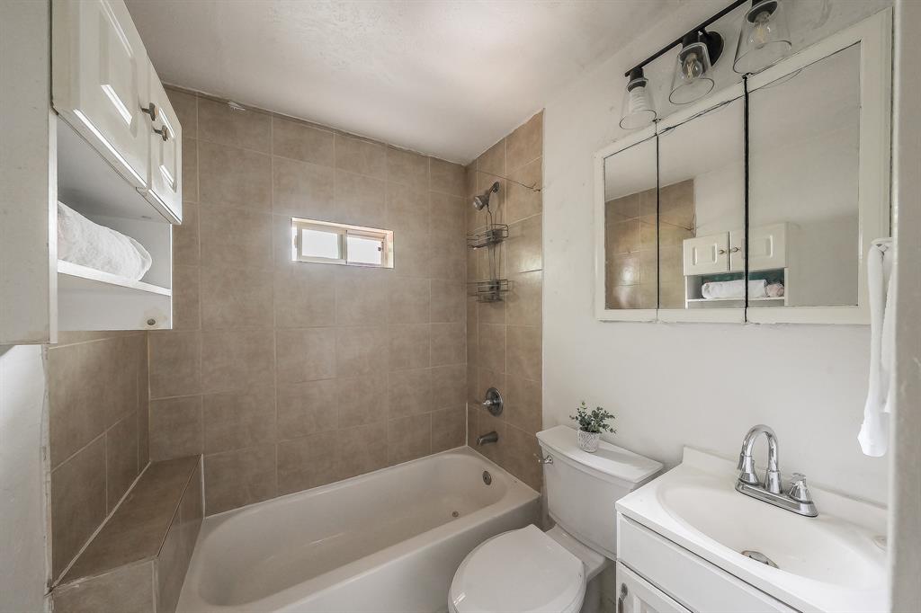5643 Cary Street Dallas, TX 75227 - Photo 21 of 23 a bathroom with a sink toilet and shower