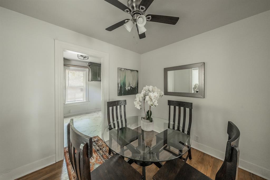 5643 Cary Street Dallas, TX 75227 - Photo 7 of 23 a view of a dining room with furniture and wooden floor