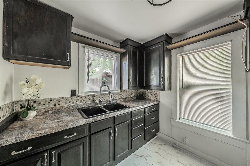 5643 Cary Street Dallas, TX 75227 - Photo 10 of 23 a bathroom with a granite countertop sink and a window
